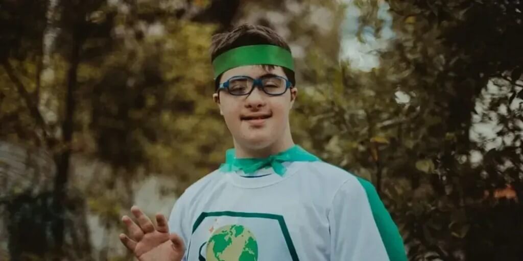 Campanha Apae Noel: participante com capa e faixa verdes, projeto de filantropia premiável da APAE Brasil